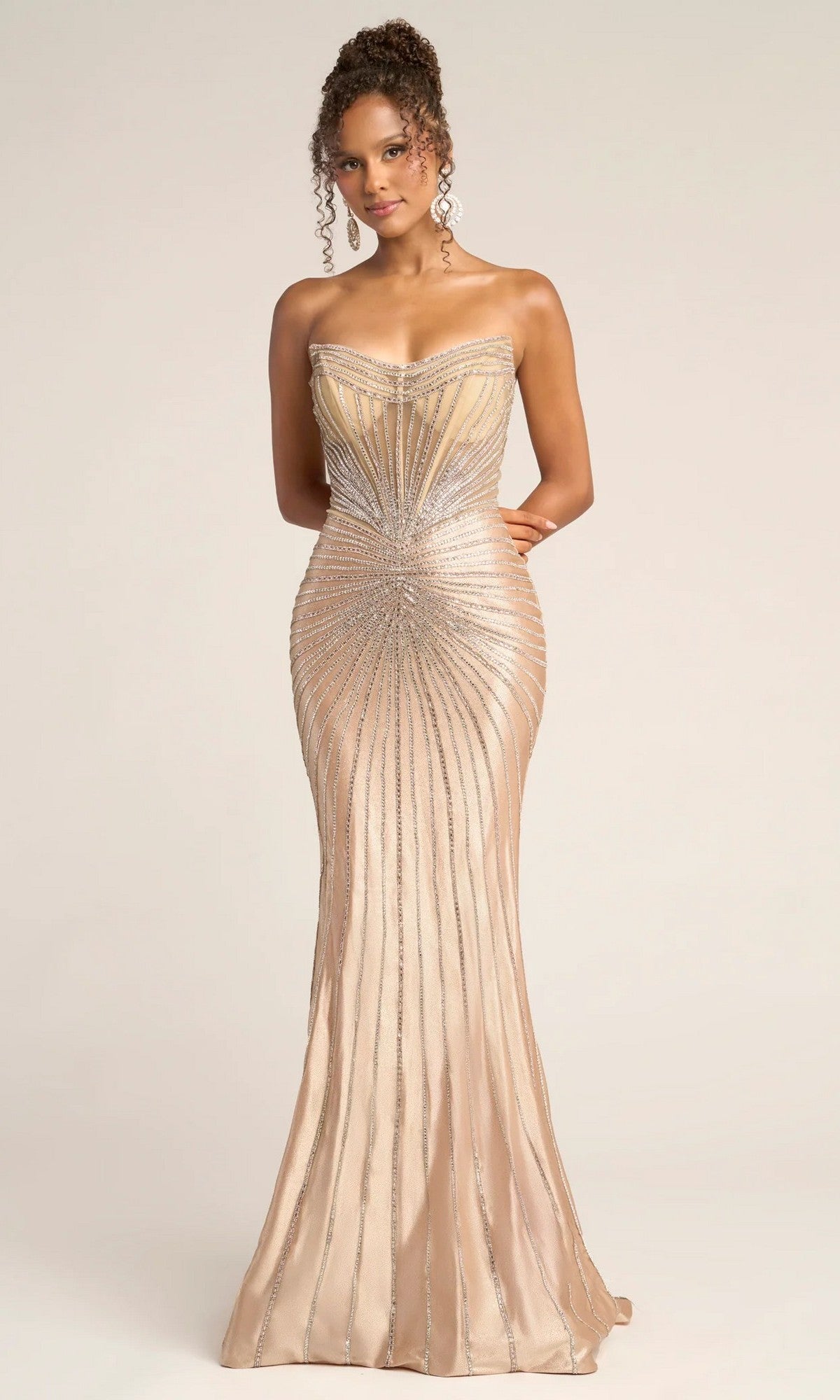 A woman wearing the Portia and Scarlett PS26250 long formal dress in champagne, detailed with strapless design and metallic silver embellishments in a radiating pattern.
